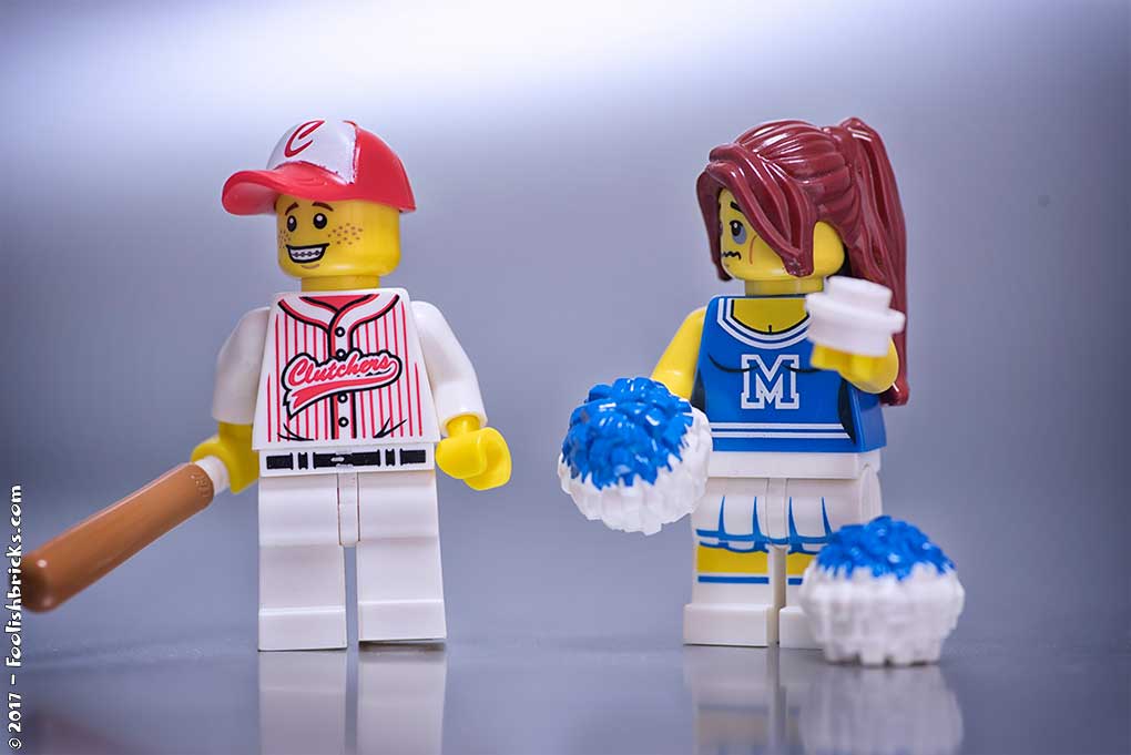 A lego baseball player accidentally gave a cheer leader a black eye with the ball