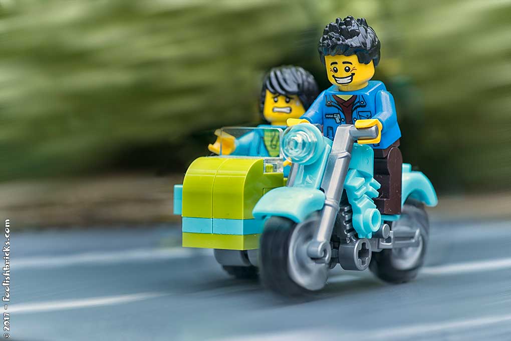 Two lego guys cruising in motorcycle with sidepod